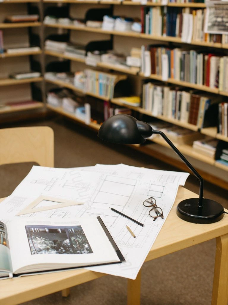 Research desk with annotated notebook and search-console style chart on a vintage monitor
